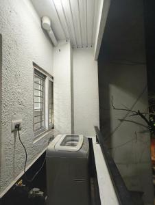 a room with a trash can in a building at M's Cozy Unwind - Hazel in Bengaluru