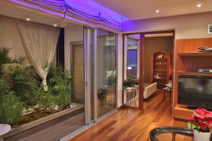 a living room with a large window with a aquarium at Sofouli Suites in Nicosia +19 photos