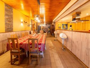 a dining room with a long table and chairs at Holiday Home - Entre Gaume et Ardenne in Florenville
