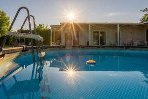 a swimming pool in front of a house at Il Giardino Di Rebecca in Ferrara