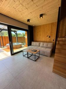 a living room with a couch and a table at Osada na Jaworowej in Radawa