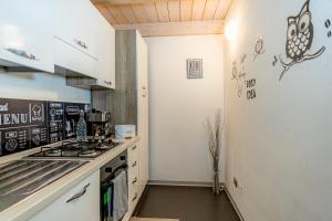a kitchen with white cabinets and a stove top oven at Il Giardino Di Rebecca in Ferrara