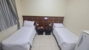 Postel nebo postele na pokoji v ubytování فندق لؤلؤة الشروق