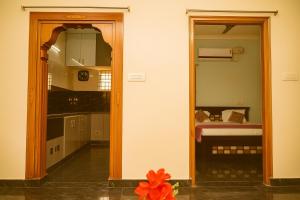 a room with a door leading to a bedroom at Madhava Home Stay in Tirupati