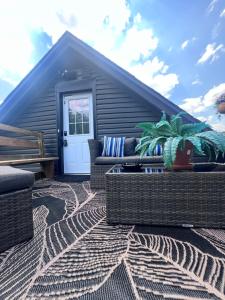 a patio with wicker furniture and a house at Niagara Escape Loft in St. Catharines +16 photos