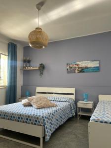 a bedroom with two beds and a lamp at A Casa di Giù B&B in Syracuse