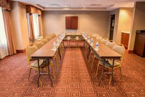 a conference room with a long table and chairs at Concord Suites by IHG in Concord