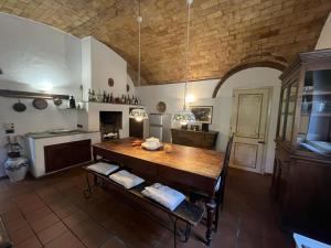 a kitchen with a large wooden table in a room at Villa Caterina 1 by falcony apartments in Montespertoli
