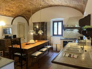 a large kitchen with a table and a sink at Villa Caterina 1 by falcony apartments in Montespertoli
