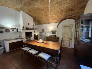 a kitchen with a large wooden table in a room at Villa Caterina 1 by falcony apartments in Montespertoli