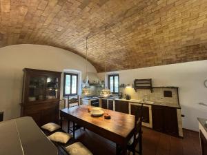 a kitchen with a wooden table in a room at Villa Caterina 1 by falcony apartments in Montespertoli +14 photos