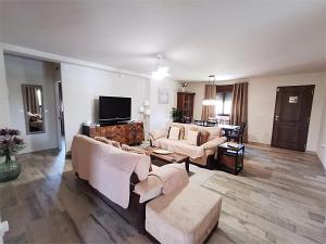 a living room with couches and a flat screen tv at Villa Casa Segunda in Lliria
