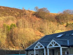 a house sitting in front of a hill at 4 Mulberry Green , Waterfoot , Rossendale, Lancs in Newchurch
