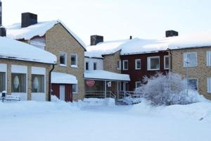 a group of houses with snow covered roofs at STF Luleå Gammelstad Hostel in Nederluleå