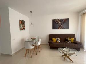 a living room with a couch and a glass table at Cris Sol 205 in Arona