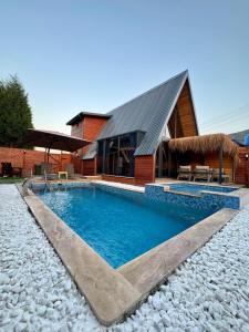 a swimming pool in front of a house at Armoni Life Bungalov in Yanık +34 photos