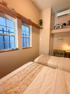 two beds in a room with a window at ケイアイコンホテルズプロパンズ in Nagoya +52 photos