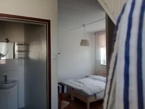 a small bedroom with a bed and a sink at Pokoje Klaudia in Darłowo +35 photos