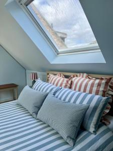 a bedroom with a bed with a skylight at The Blue Loft in Anstruther