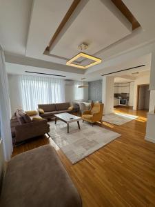 a living room with a couch and a table at Riga Lux Apartment Prishtina in Pristina