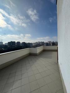 a balcony with a view of a city skyline at Riga Lux Apartment Prishtina in Pristina