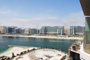 a view of a city with a beach and buildings at KeyRock - Dubai Marina Stay with Pool & Gym in Dubai