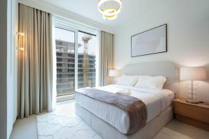 a bedroom with a bed and a large window at KeyRock - Dubai Marina Stay with Pool & Gym in Dubai