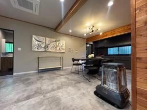 a living room with a dining room table and a kitchen at 森のテラス in Karuizawa