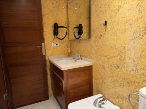 a bathroom with a sink and a phone on the wall at Casa Maricarmen villa in Tacoronte +35 photos