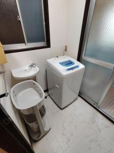 a small bathroom with a toilet and a sink at さんこ戸建て1号棟 in Takamatsu +12 photos