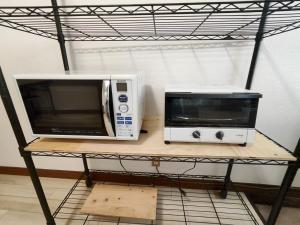 two microwaves are sitting on a shelf at さんこ戸建て1号棟 in Takamatsu
