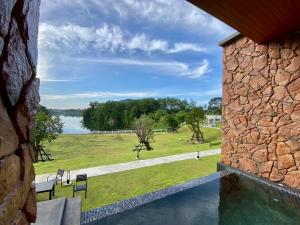 a view of a lake from a stone building at รามโรมวัลเลย์รีสอร์ท Ramrom Valley Resort in Ban Loeng
