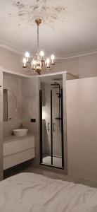 a bathroom with a sink and a chandelier at Gouda city center apartment with private garden and 2 bicycles in Gouda