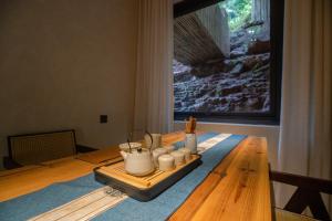 a table with a tray of candles on it at Twilight Cloud Spring Tree Private Hot Spring Homestay Bifengxia Panda Base Store in Ya'an