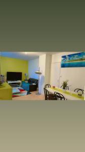 a living room with a couch and a table at LA VILLa in La Rochelle