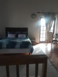 a bedroom with a bed and a desk and a window at Albertinia Homes in Albertinia +9 photos