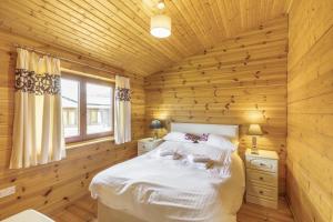 a log cabin bedroom with a bed and a window at 2 Bed in Llandinam oc-t32993 in Llandinam