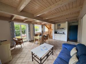 a living room with a blue couch and a table at Hof von Bothmer GmbH in Bad Zwischenahn