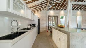 a kitchen with a sink and a counter top at Villa Taramille by Villa Finder in Kerobokan +33 photos