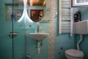 a bathroom with a sink and a toilet and a mirror at Pine in Vrela
