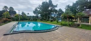 an image of a swimming pool in a yard at Villa Segar Alam Puncak in Cinengangirang