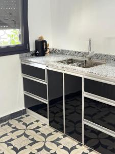 a kitchen with a counter top and a sink at Apartement khadija in Azrou +19 photos