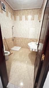 a bathroom with a toilet and a sink at Masa House Luxor in Luxor