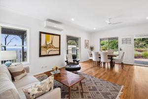 a living room with a couch and a table at Montville Retreat offgrid luxury in Montville
