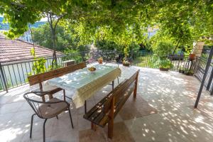 a table and two benches on a patio at Adriana Apartments in Herceg-Novi