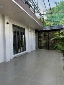 an empty courtyard of a house with a glass door at Happy House Sài Gòn in Ho Chi Minh City