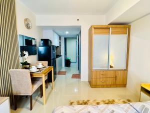 a living room with a dining table and a kitchen at J Tower Residences in Mandaue City