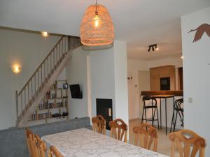 a dining room and kitchen with a table and chairs at Apartment in Antwerp near Verbeke Museum in Puivelde +15 photos