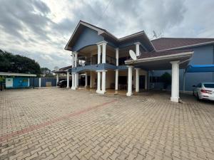 a blue house with a car parked in front of it at Christie's Apartment in Accra