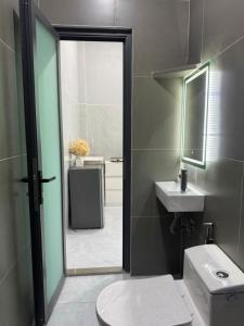 a bathroom with a toilet and a sink and a mirror at Happy House Sài Gòn in Ho Chi Minh City +16 photos